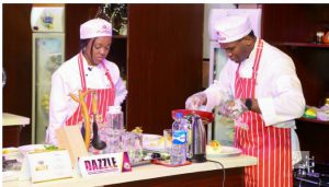 The CMD and wife of the CMD (WCMD) concentrate on their dish for the President.